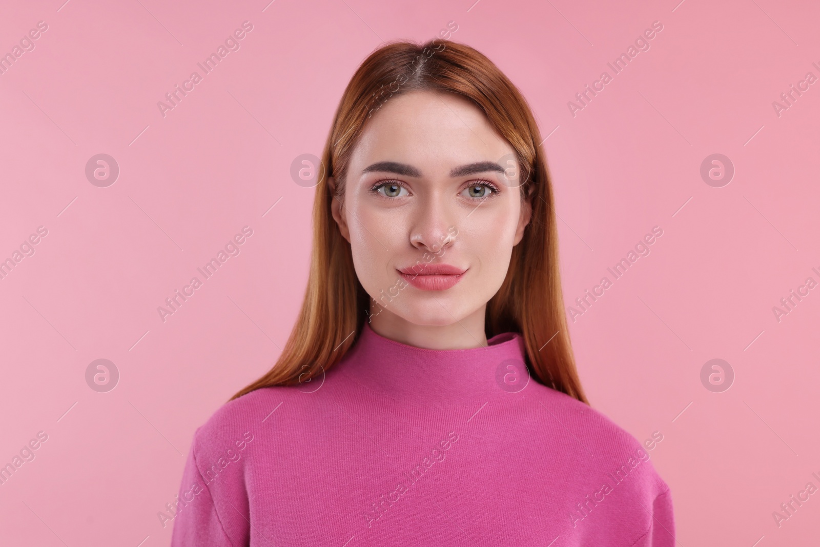 Photo of Portrait of young woman on pink background