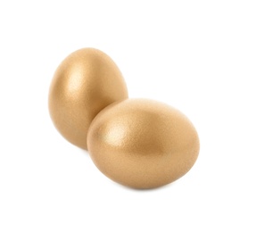 Two shiny golden eggs on white background
