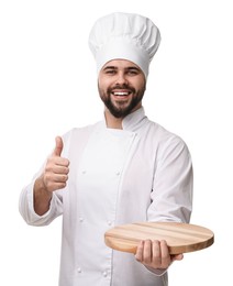 Happy young chef in uniform holding wooden board and showing thumb up on white background