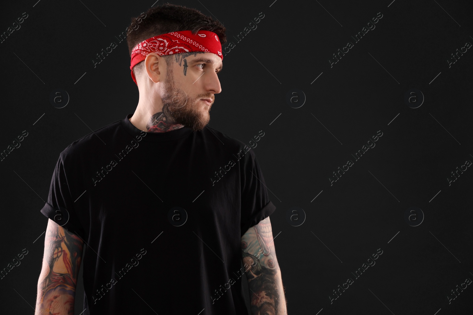 Photo of Handsome hipster man on black background. Space for text