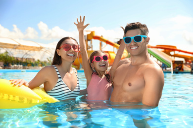 Photo of Happy family in swimming pool. Summer vacation