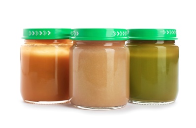 Jars with healthy baby food on white background