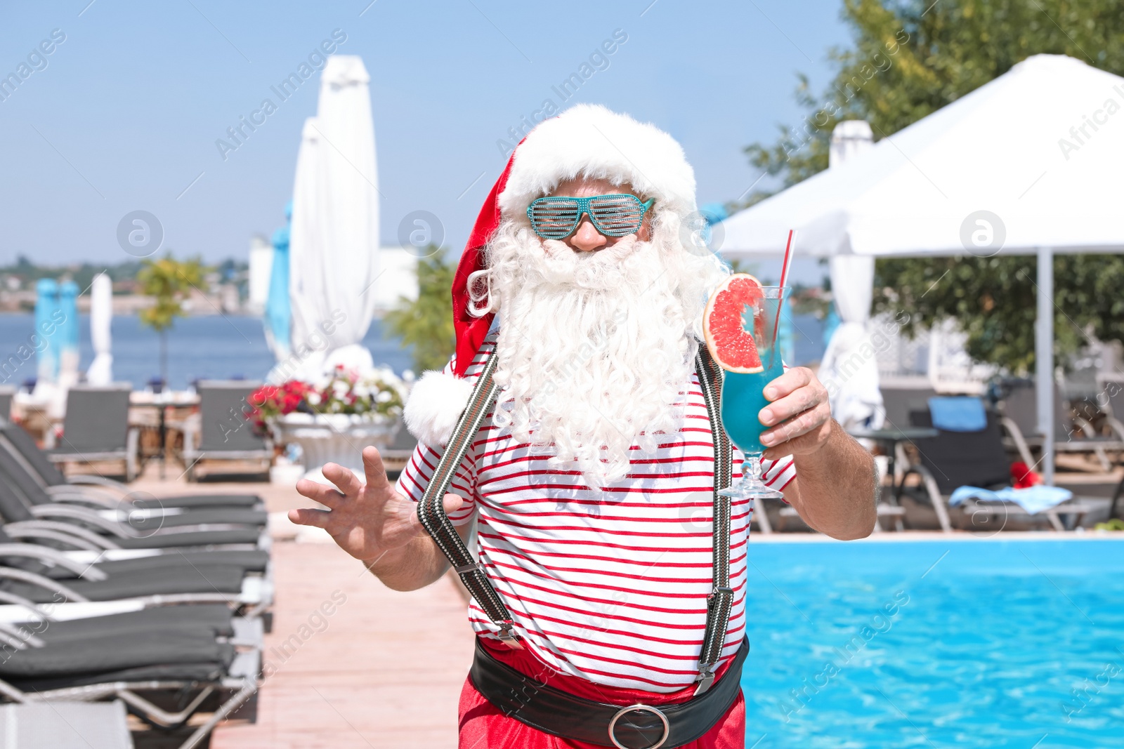 Photo of Authentic Santa Claus with cocktail near pool at resort