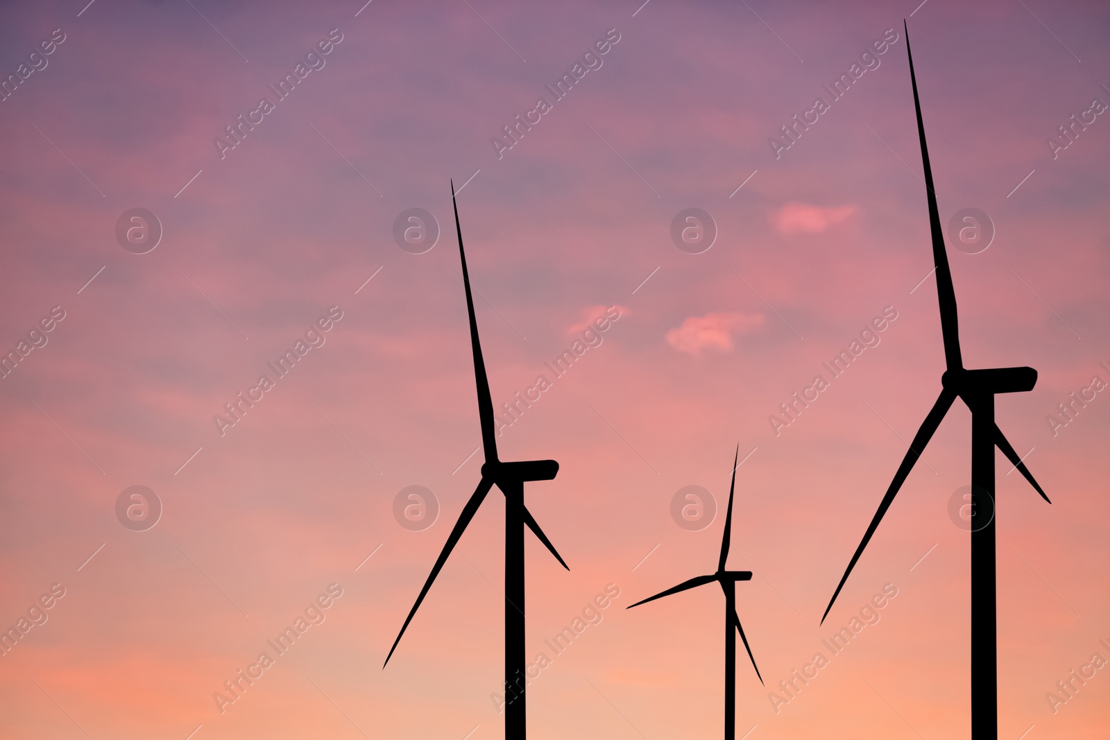 Image of Silhouettes of wind turbines at sunset. Alternative energy source