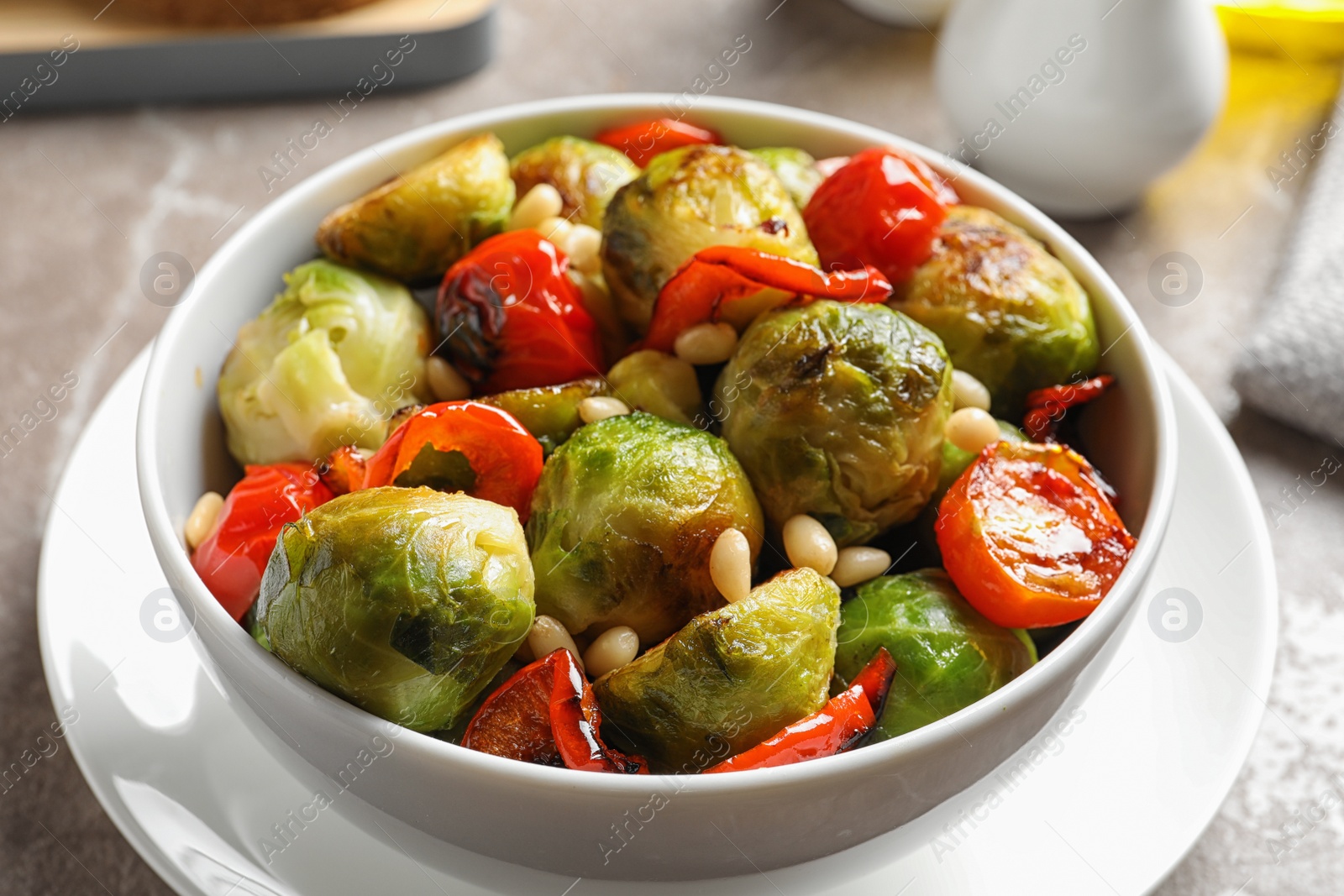 Photo of Bowl of salad with Brussels sprouts on table, closeup