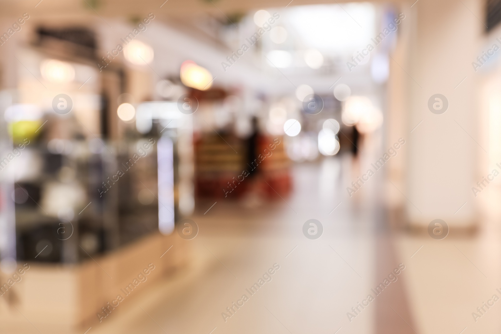 Photo of Blurred view of modern shopping mall interior. Bokeh effect