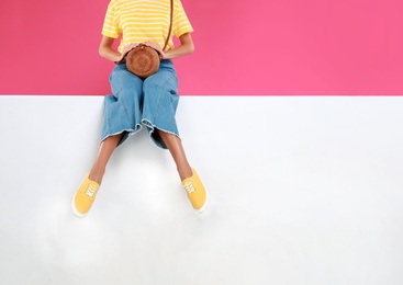 Photo of Woman wearing stylish shoes on color background, closeup