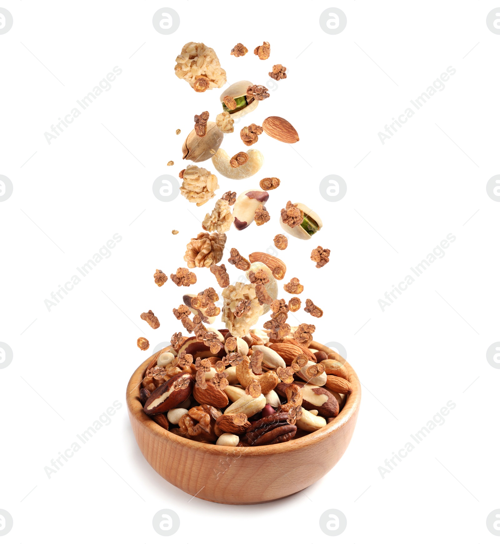 Image of Delicious granola and nuts falling into bowl on white background. Healthy snack 