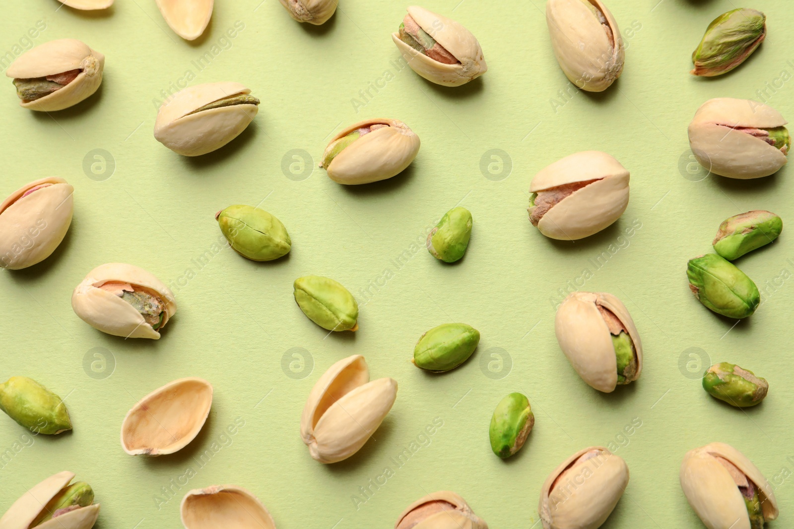 Photo of Composition with organic pistachio nuts on color background, flat lay