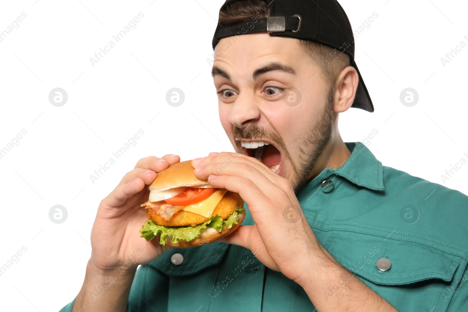 Photo of Handsome man eating tasty burger isolated on white