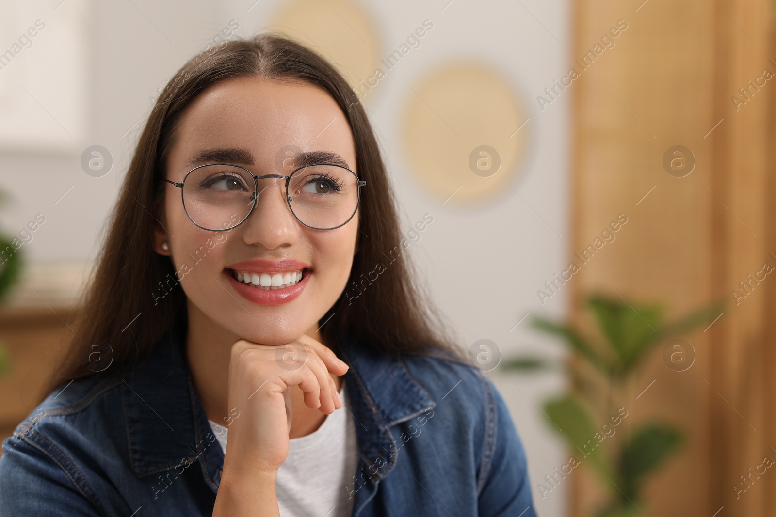 Photo of Portrait of beautiful young woman with glasses indoors, space for text. Attractive lady posing for camera