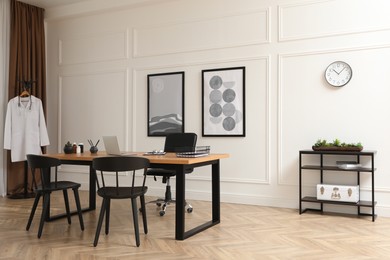 Photo of Modern medical office interior with doctor's workplace and chairs