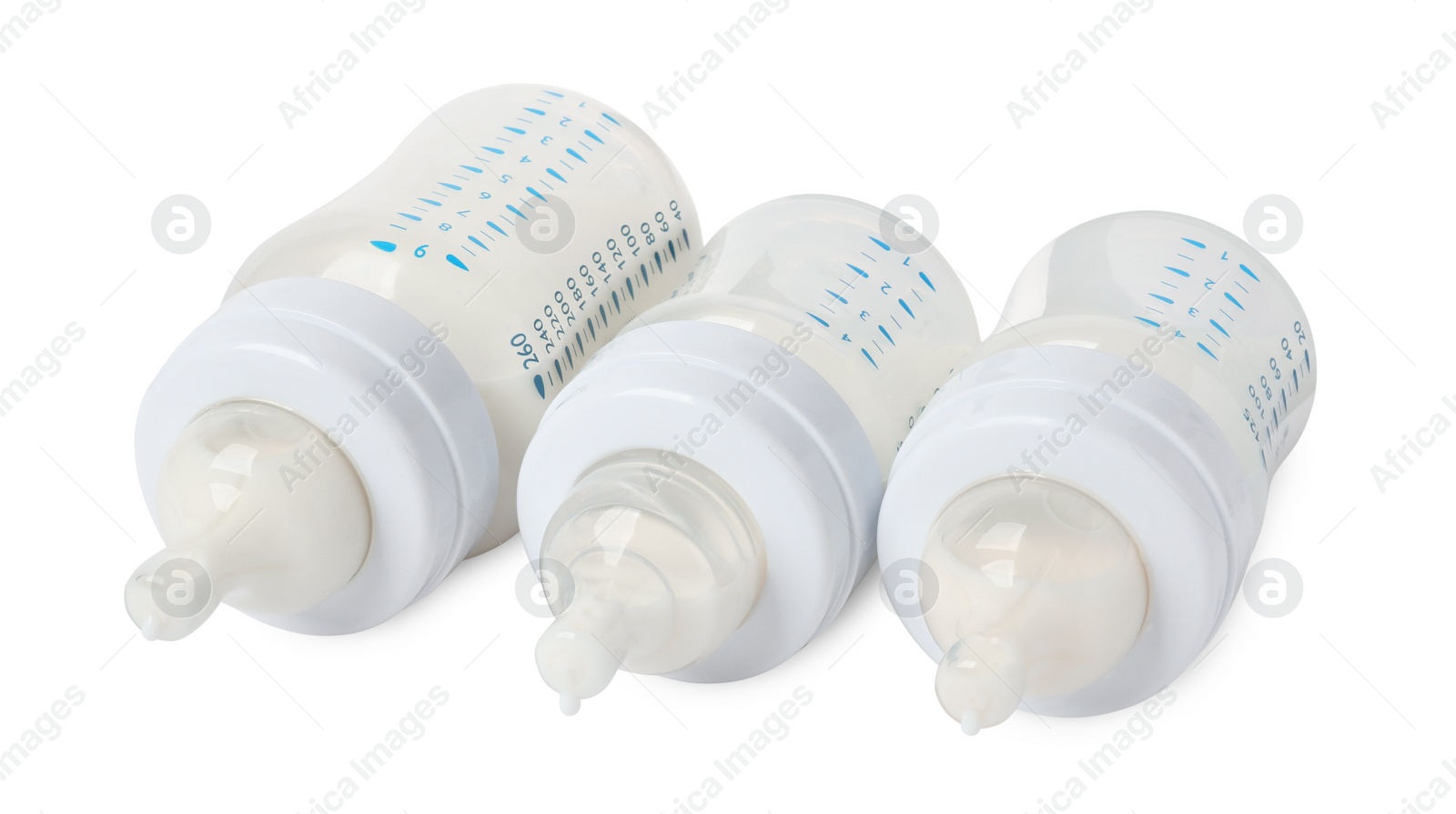 Photo of Three feeding bottles with infant formula on white background