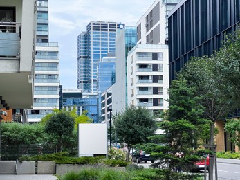 Photo of City street with beautiful buildings and green trees