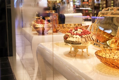 DUBAI, UNITED ARAB EMIRATES - NOVEMBER 04, 2018: Store with luxury sweets in shopping mall, view through glass wall