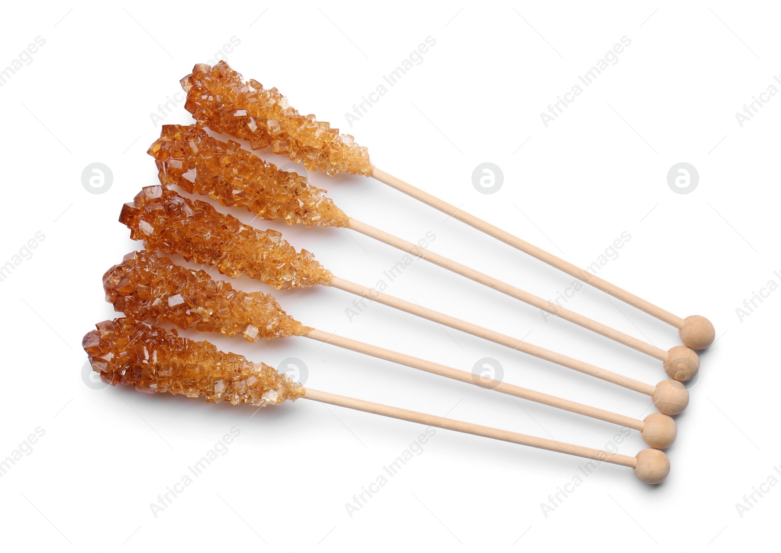 Photo of Wooden sticks with sugar crystals isolated on white, top view. Tasty rock candies