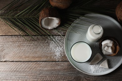 Photo of Flat lay composition with coconut milk on wooden table, space for text