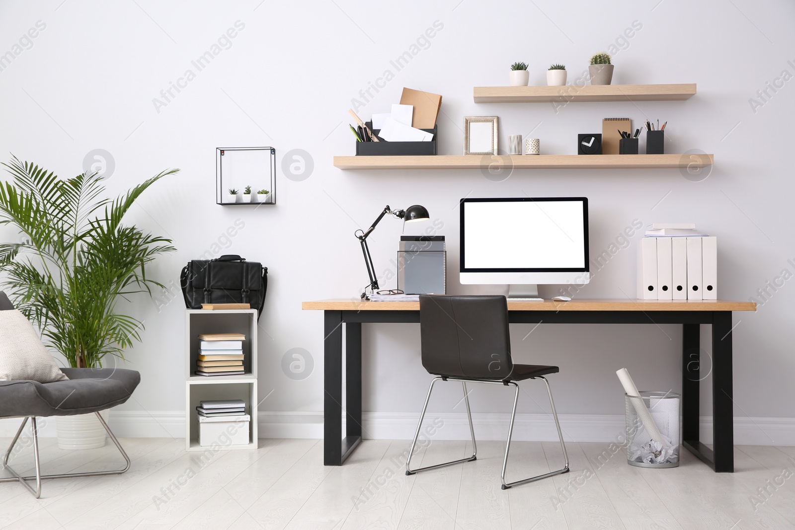Photo of Modern computer on table in office interior. Stylish workplace