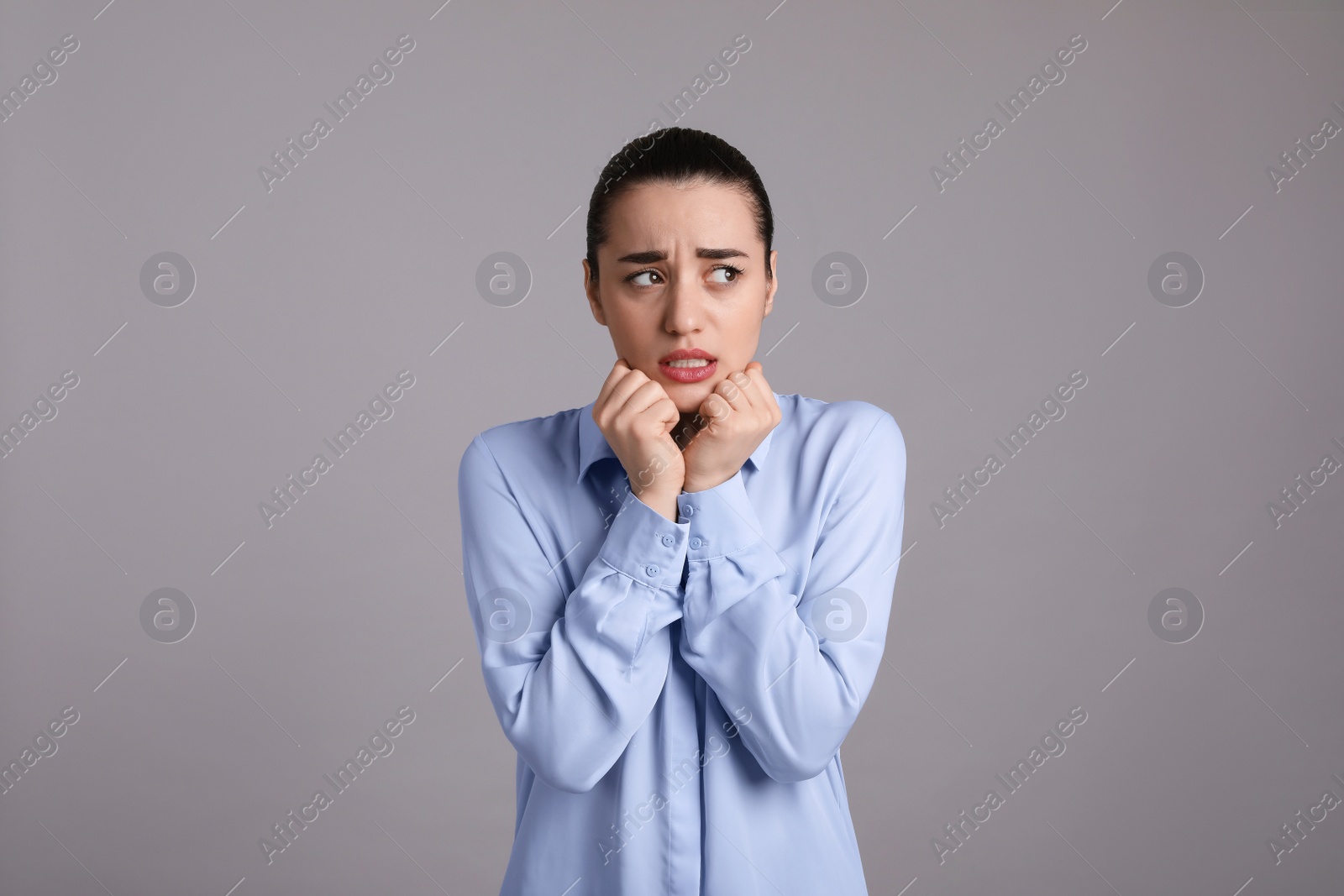 Photo of Portrait of emotional young woman on light grey background. Personality concept