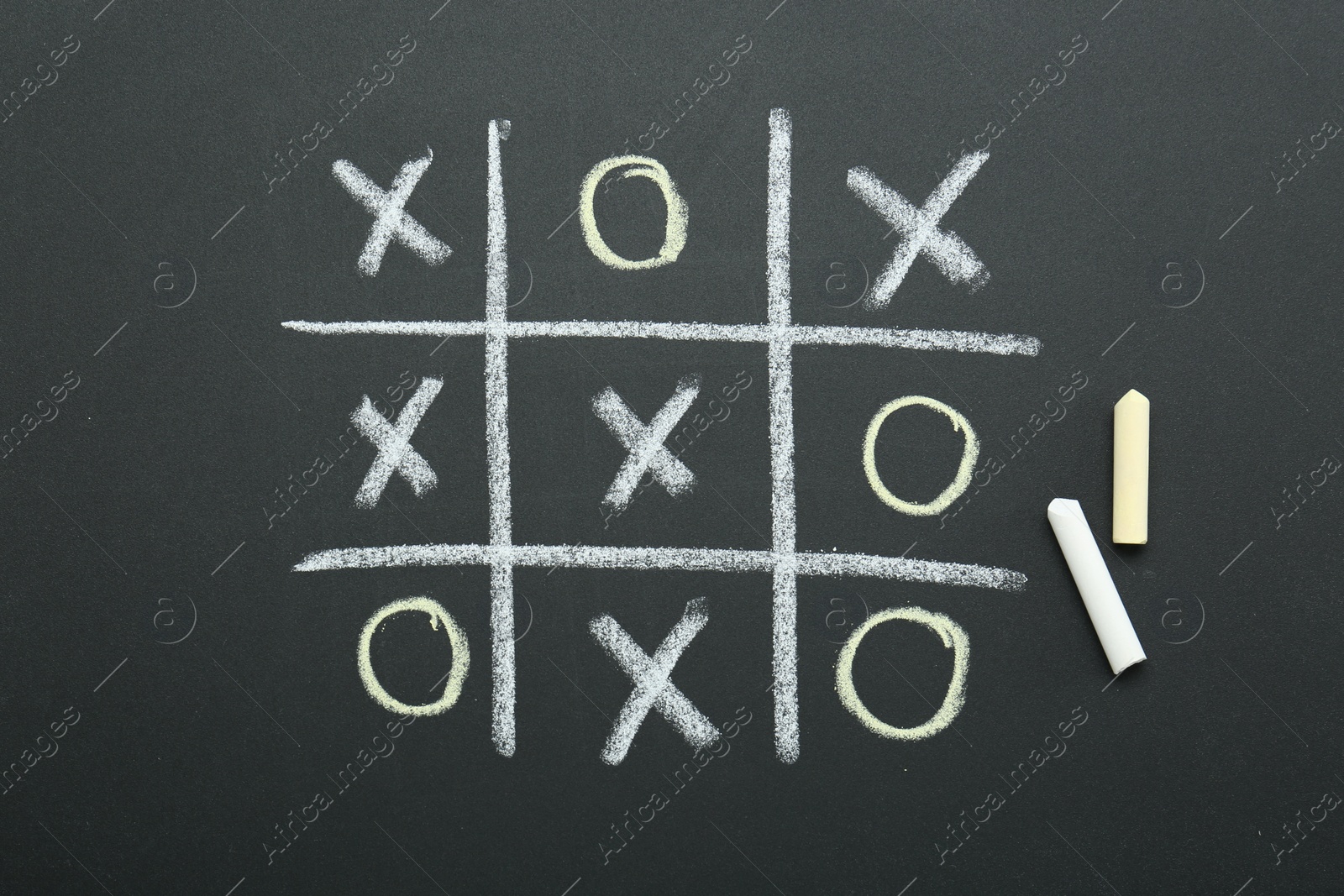 Photo of Tic tac toe game drawn on chalkboard, top view