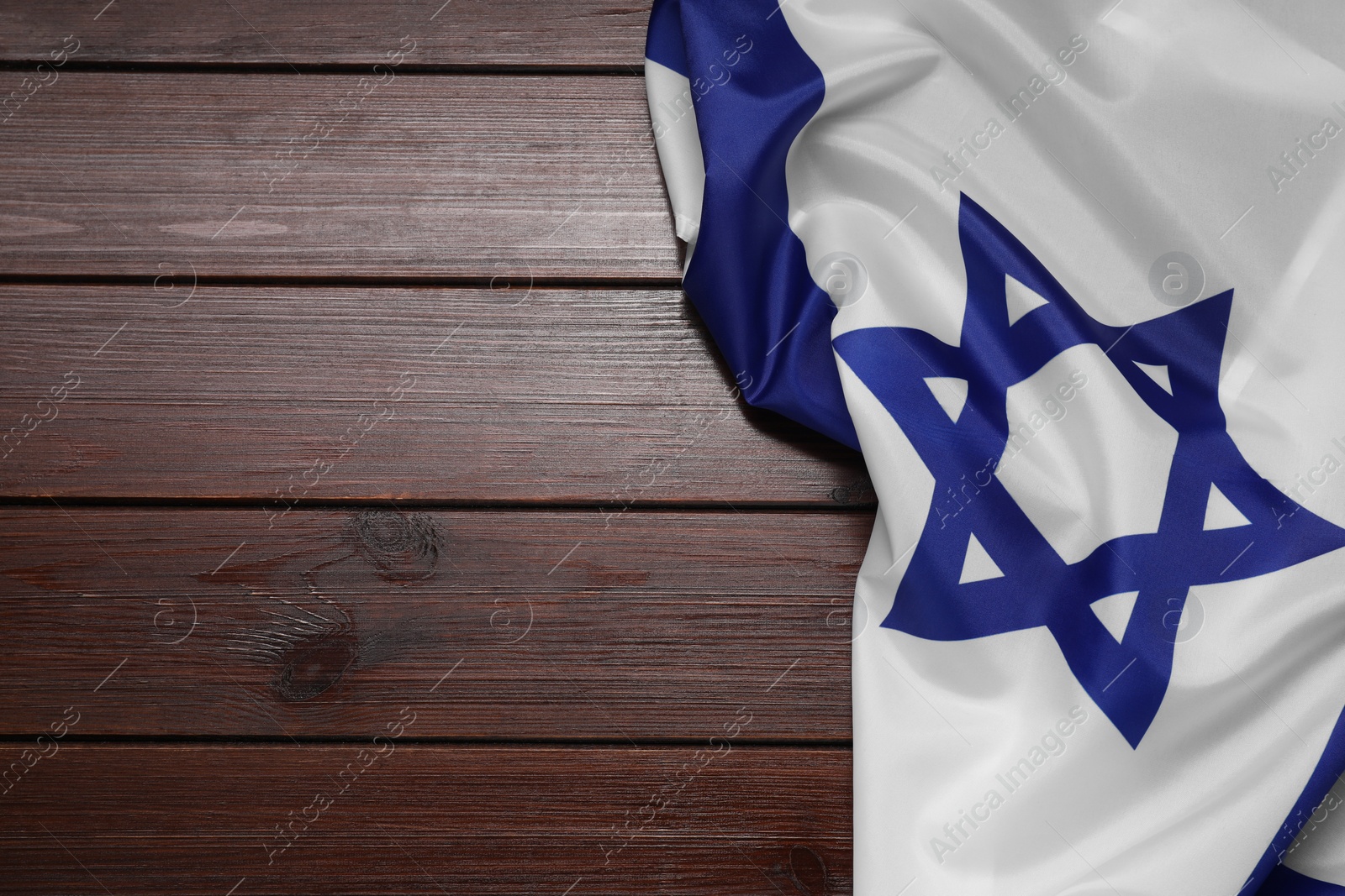 Photo of Flag of Israel on wooden background, top view and space for text. National symbol