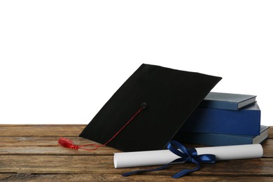 Photo of Graduation hat, books and diploma on wooden table against white background, space for text