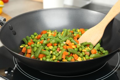Photo of Cooking tasty vegetable mix in wok pan, closeup
