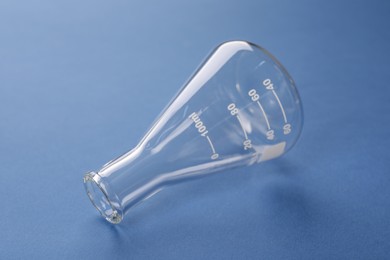 Photo of One flask on blue background. Laboratory glassware