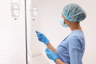 Nurse setting up IV drip in hospital