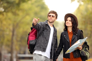 Photo of Couple of travelers with map on city street