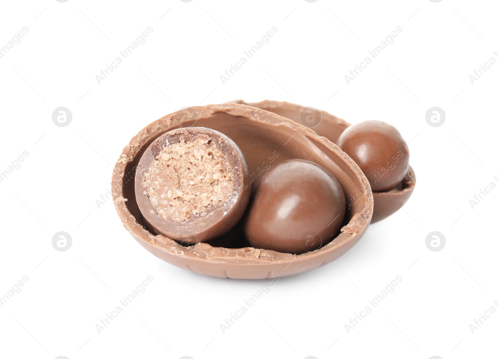 Photo of Broken chocolate Easter egg with candies on white background