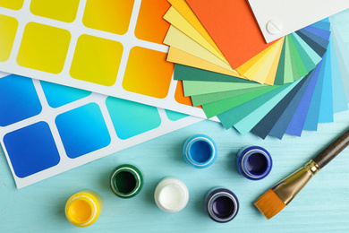 Photo of Flat lay composition with color palettes on light blue wooden background