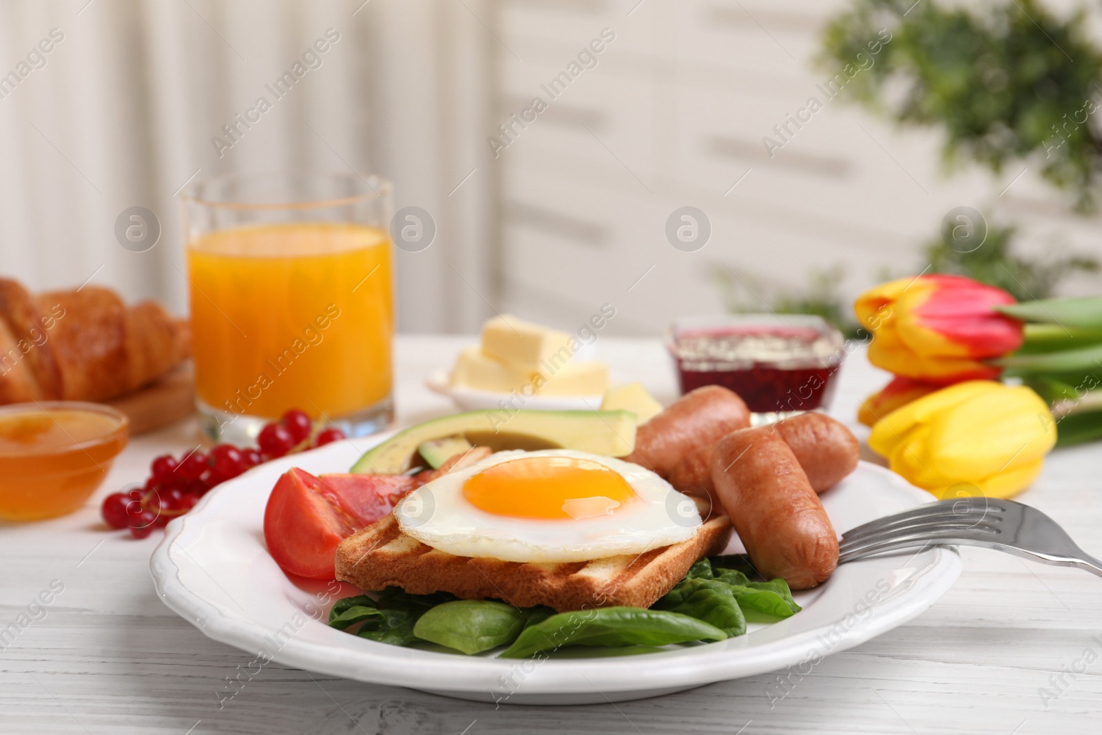 Photo of Delicious breakfast with fried egg served on white wooden table