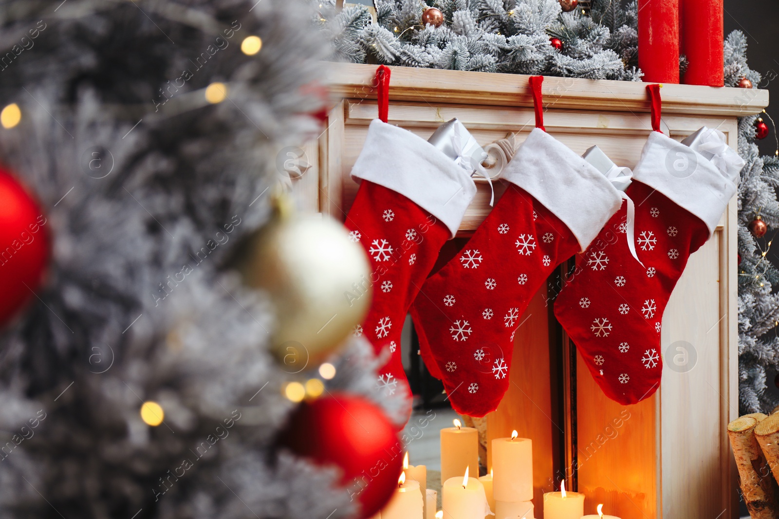 Photo of Fireplace with Christmas stockings in festive room interior