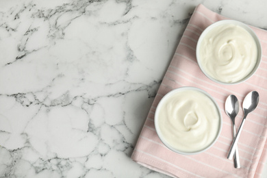 Photo of Tasty organic yogurt on white marble table, top view. Space for text