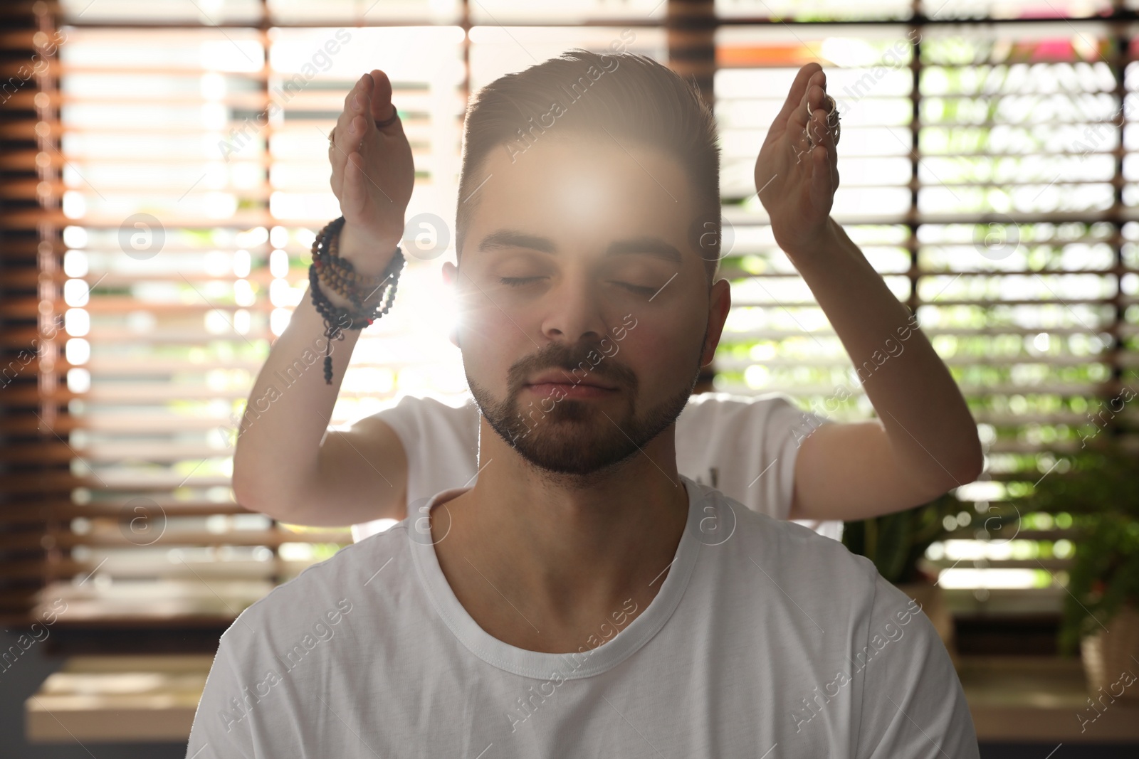 Photo of Young man during healing session in therapy room