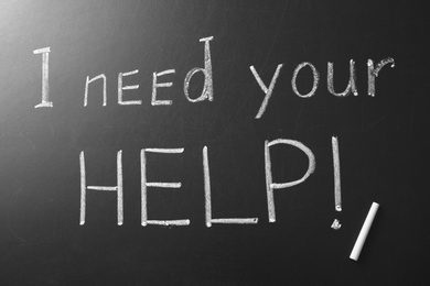 Photo of Phrase "I need your help" written on chalkboard, top view