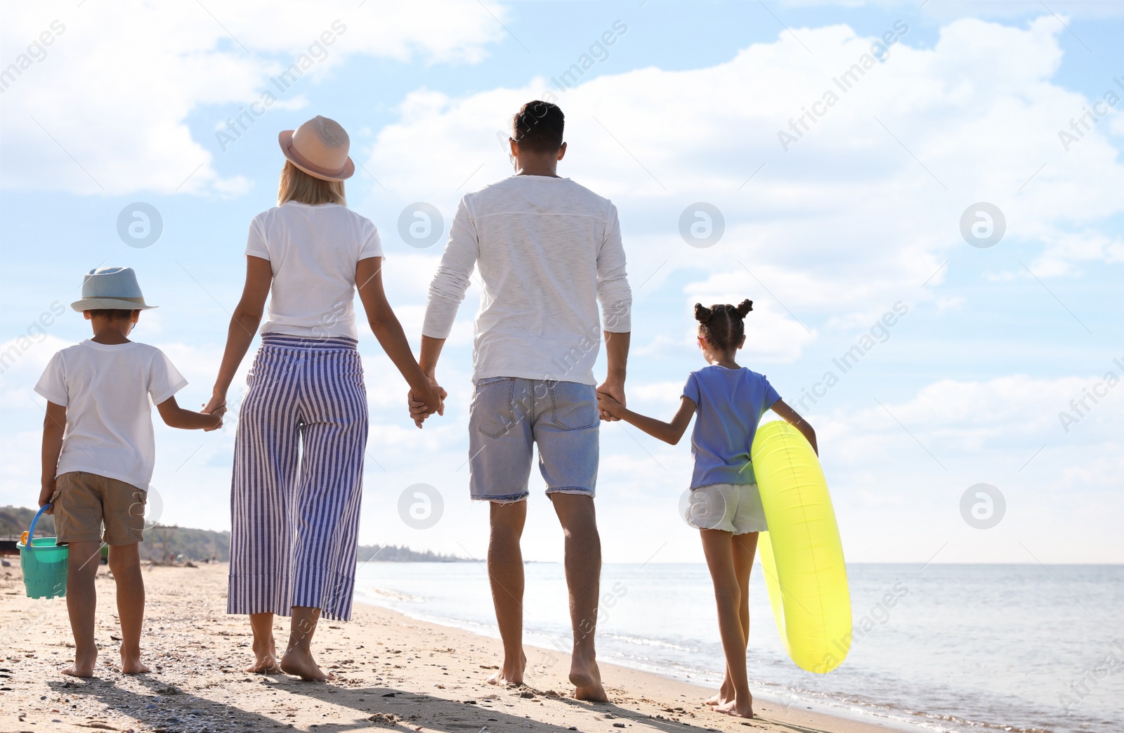 Photo of Family at beach on sunny summer day