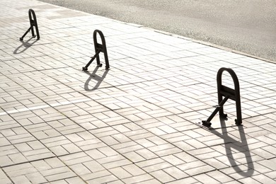 Photo of Parking barriers on pavement near road outdoors
