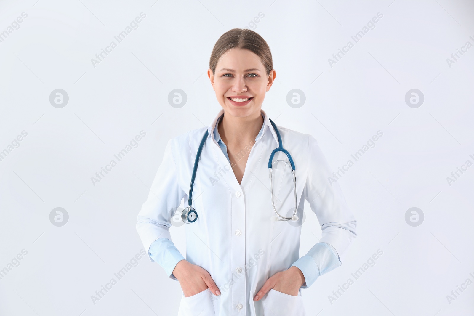 Photo of Portrait of young doctor against white background