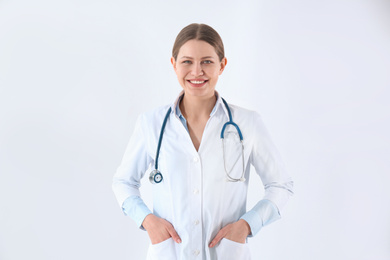 Photo of Portrait of young doctor against white background