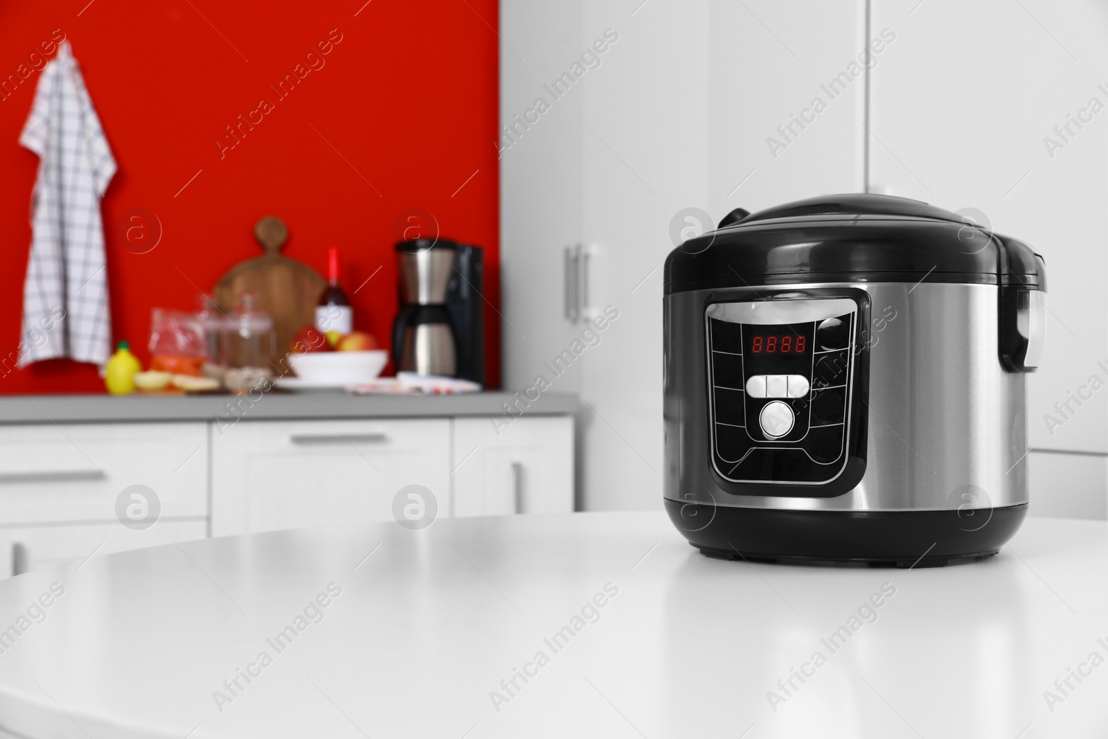 Photo of New modern multi cooker on table in kitchen. Space for text