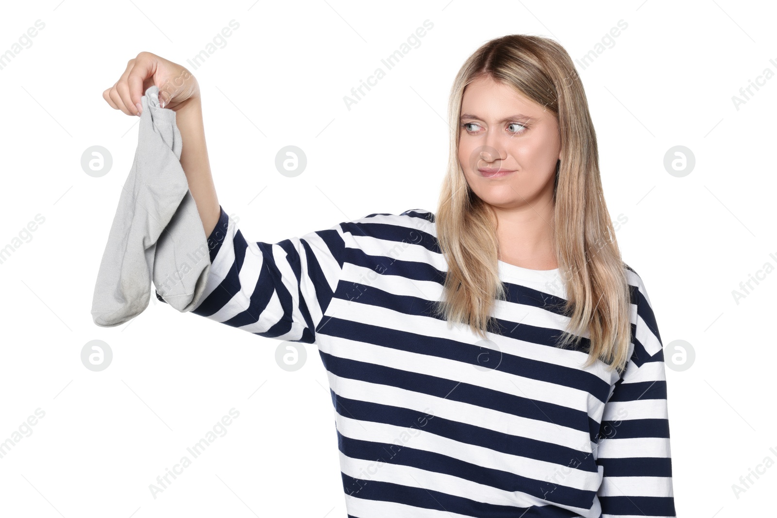 Photo of Young woman feeling bad smell from dirty socks isolated on white