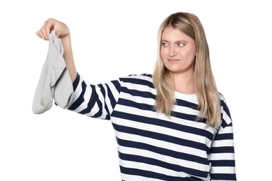 Photo of Young woman feeling bad smell from dirty socks isolated on white