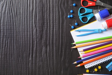 Photo of Different school stationery with space for design on wooden background, flat lay