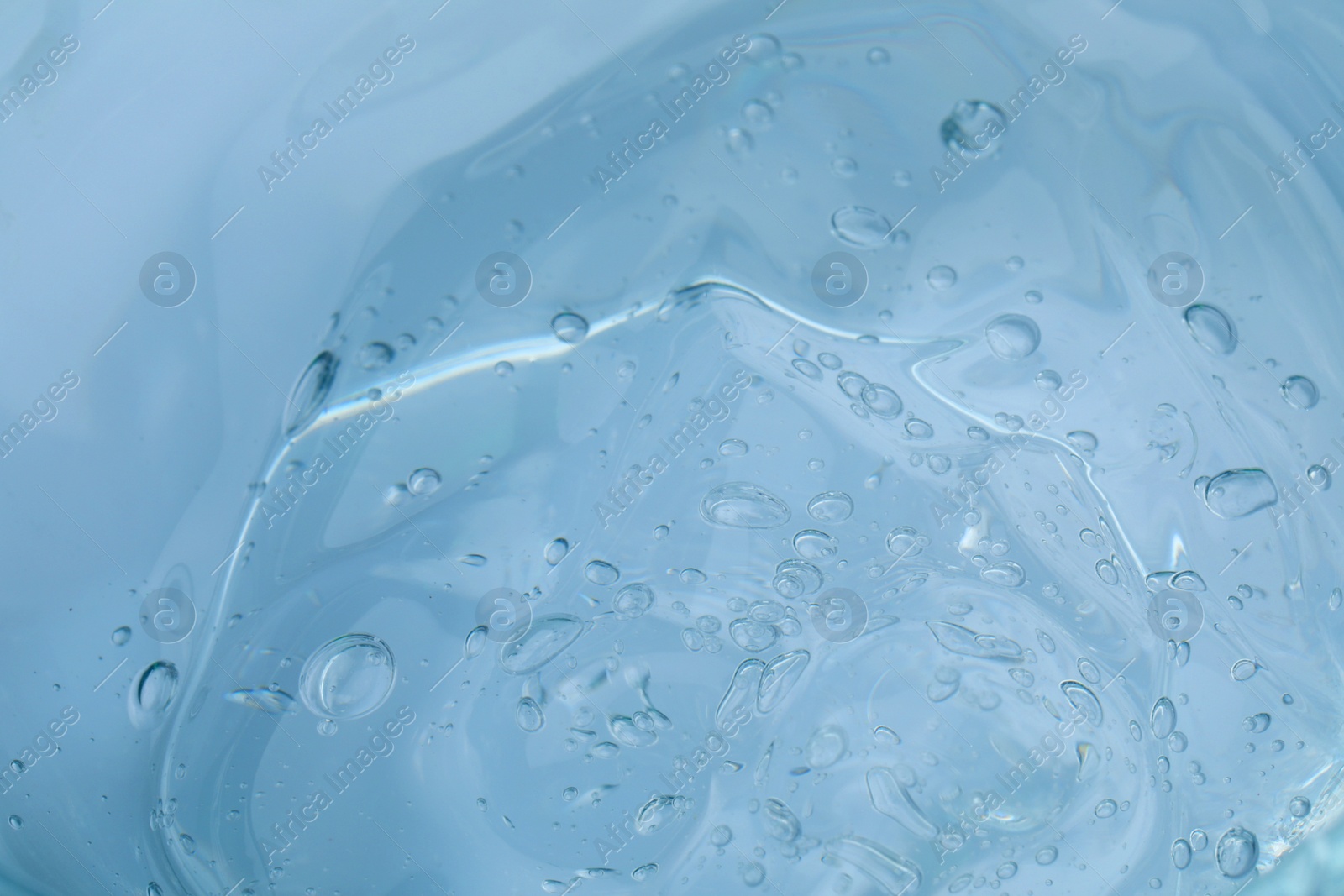 Photo of Sample of transparent cosmetic gel as background, closeup