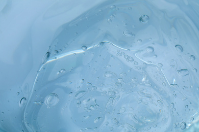 Photo of Sample of transparent cosmetic gel as background, closeup