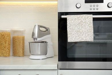 Photo of Clean towel hanging on oven handle in kitchen