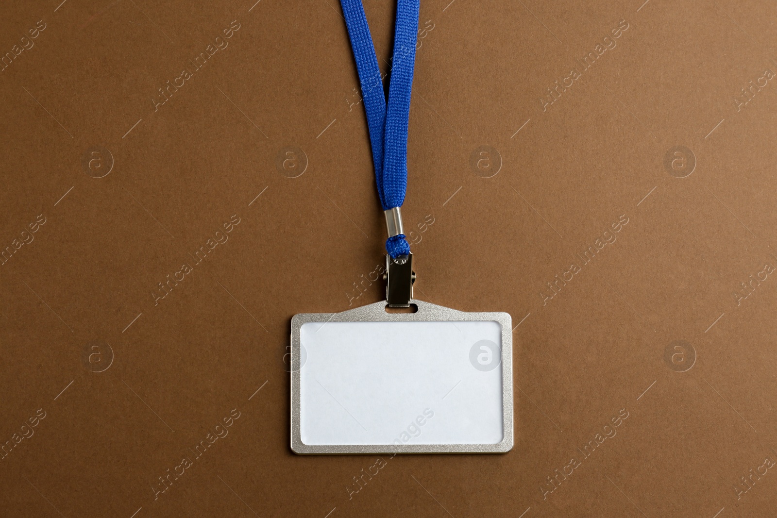 Photo of Blank badge on brown background, top view. Mockup for design