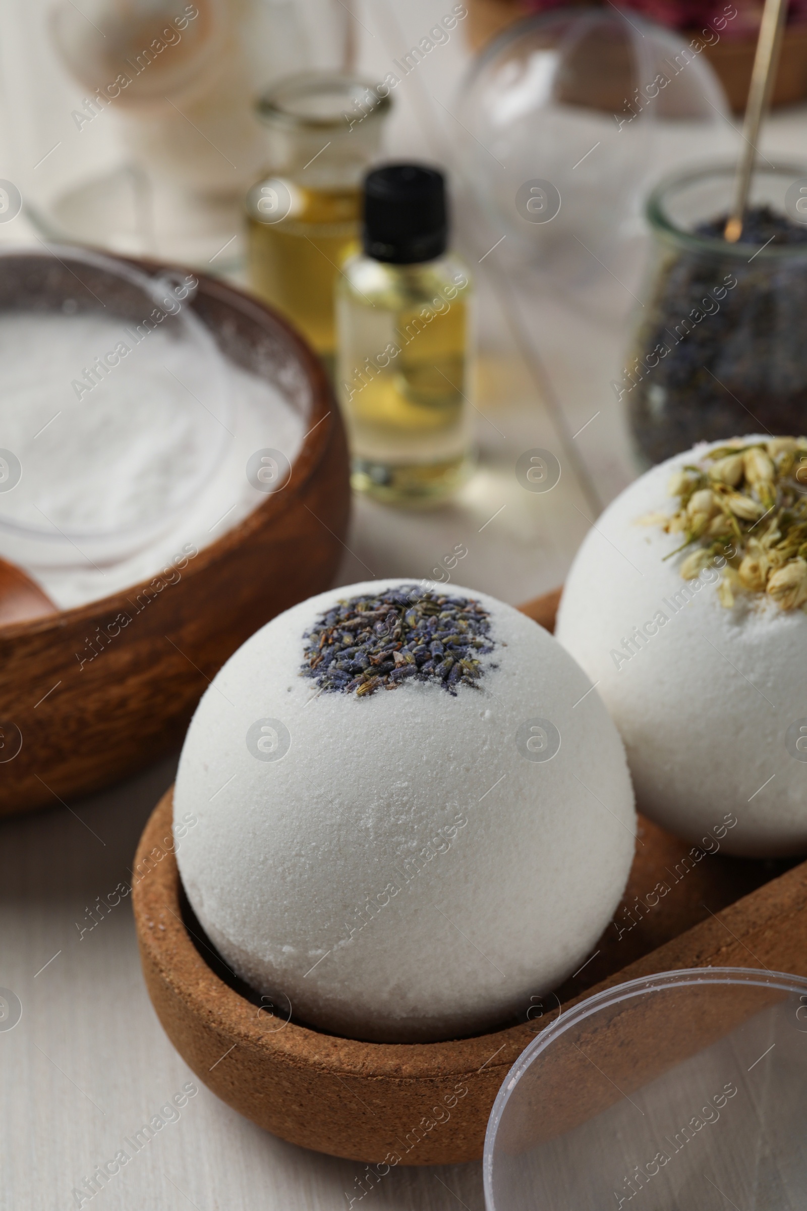 Photo of Tray with different bath bombs on white wooden table